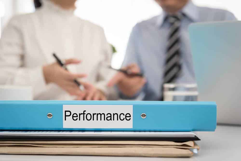 Performance management binder on desk
