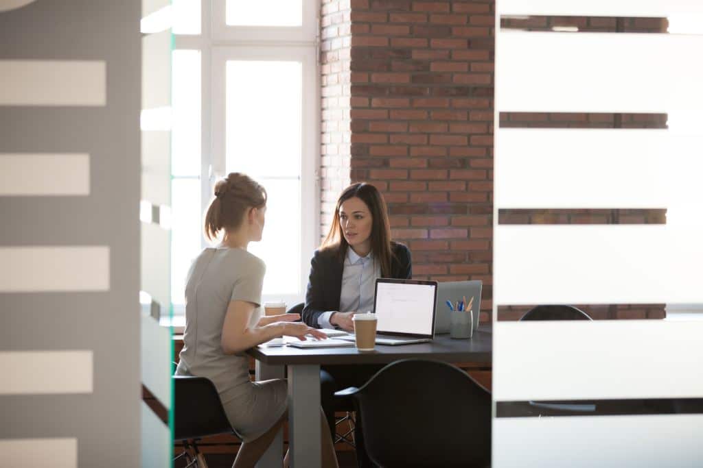 Businesswomen planning work in meeting room with table and laptop